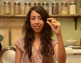 a woman holding a single bean