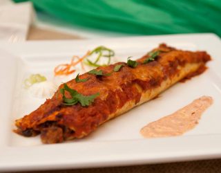 a plate of one Black Bean Seafood Enchiladas