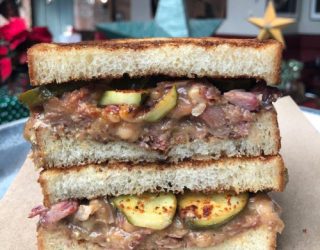 a close up of the inside of a white bean and smoked pork sandwich on texas toast