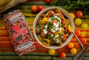 a bowl of red bean mediterranean salad with a package of red beans