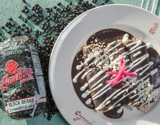 a plate of canal bistro enfrijoladas next to a package of black beans