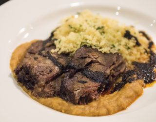 a plate of braised short rib and berbere split peas