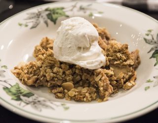 a plate of bean cobbler topped with vanilla ice cream