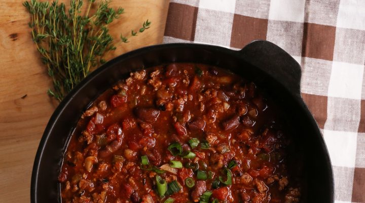 a cast iron pot full of Creole-Style Pork & Red Bean Chili