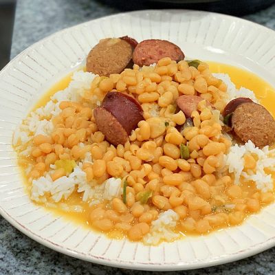 a plate full of Instant Pot Navy Beanswith rice and sausage