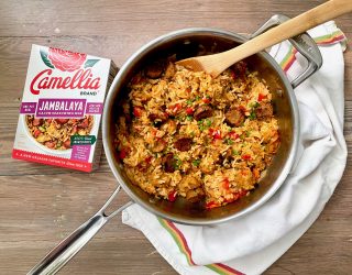 Pot of Vegan Jambalaya with Camellia Brand's Jambalaya Seasoning Mix next to it