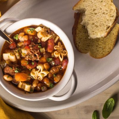 a bowl of kid friendly instant pot pasta fagioli with a side of bread