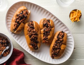 4 kid friendly sloppy joe hot dogs topped with ground beef and black beans on a plate